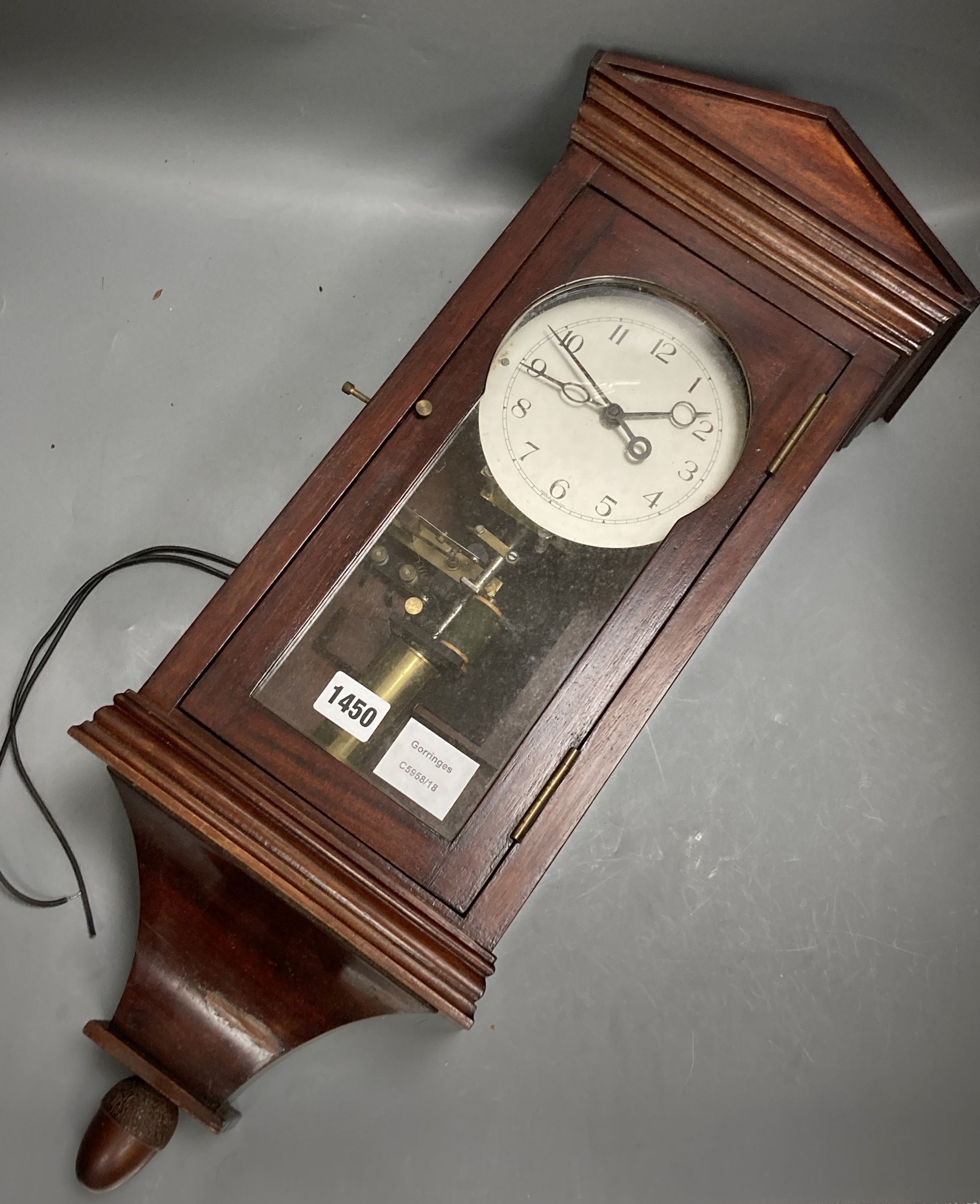 An early 20th century mahogany cased electric wall clock, with acorn pendant, height 66cm